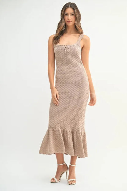 Pear Daisy ruffled hem sleeveless crochet knit midi dress in a home and garden setting, showcasing the stylish design and fabric details.