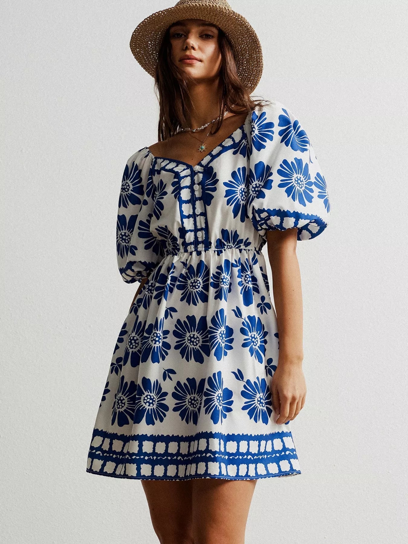 Floral print puff sleeve mini dress by Pear Daisy, showcasing a stylish design with vibrant flower patterns and puff sleeves.
