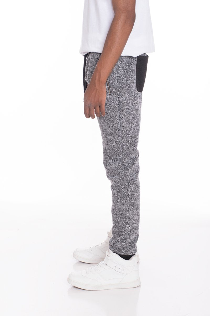 Black and grey static contrasted joggers by Lime Milo, showing the stylish tapered pants with elastic waistband and side pockets.