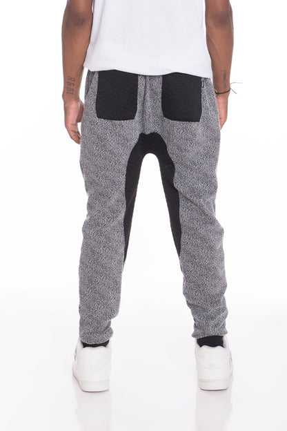 Black and grey Lime Milo static contrasted joggers pants with a relaxed fit and elastic waistband, shown flat on a white background.