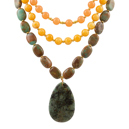 Green Chrysocolla pendant on a gold necklace, jewelry featuring a vibrant green gemstone set in a stylish gold chain.