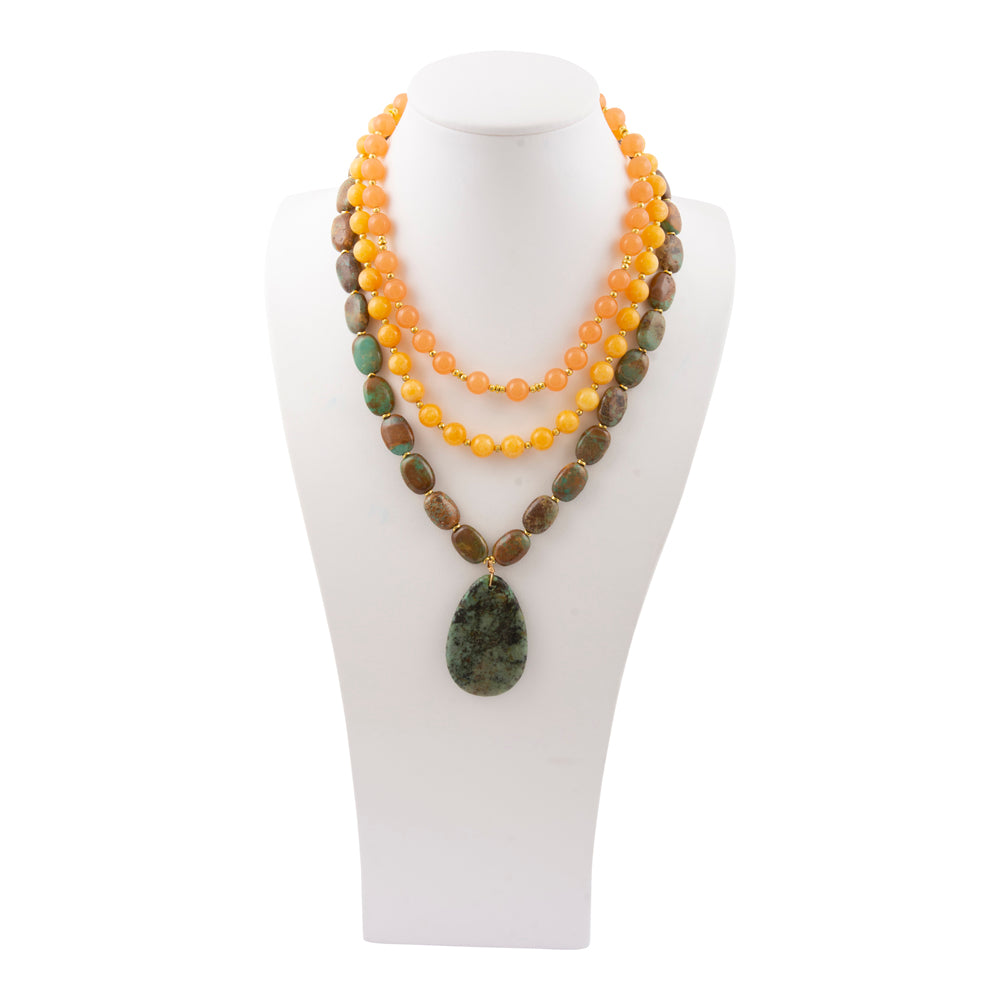 Green Chrysocolla pendant on a gold necklace, jewelry piece with vibrant green stone and elegant chain design.