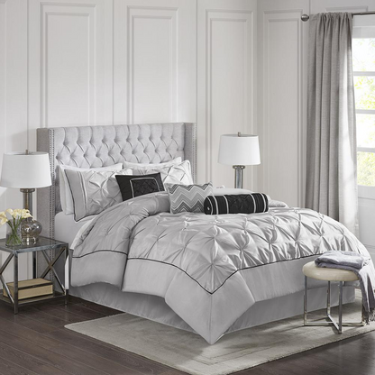 Grey Laurel 7-piece tufted comforter set by Start2Finish, includes comforter and matching bedding accessories on a bed.