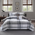 Start2Finish plaid comforter set with a cozy, multicolored checkered pattern on a bed in a well-lit bedroom scene.