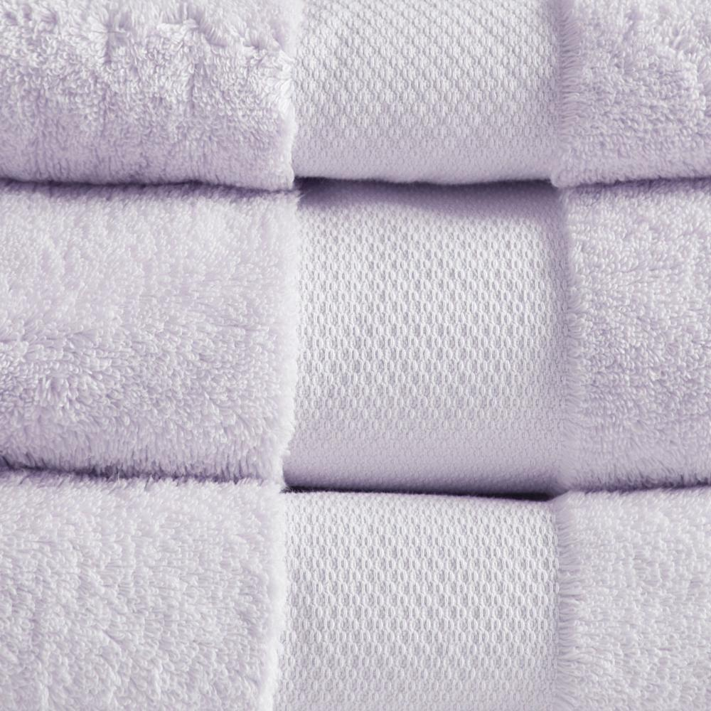 Set of six white cotton bath towels from Start2Finish, plush and soft, neatly folded on a clean bathroom surface.