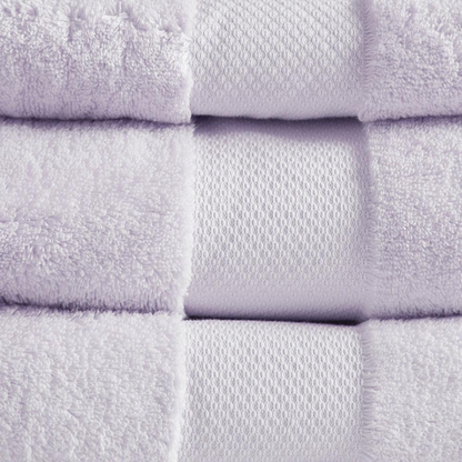 Set of six white cotton bath towels from Start2Finish, plush and soft, neatly folded on a clean bathroom surface.