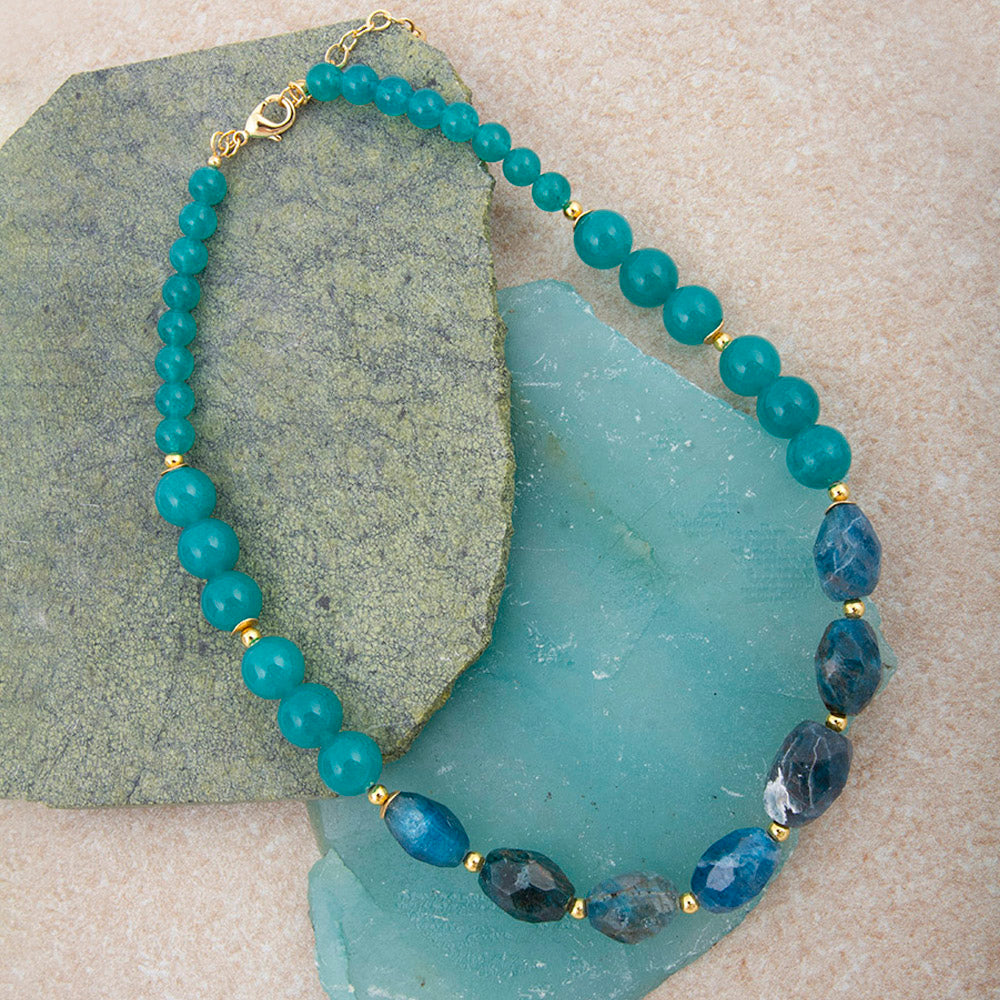 Teal apatite and jade nugget golden necklace with a delicate chain, showcasing vibrant blue-green stones and gold accents.