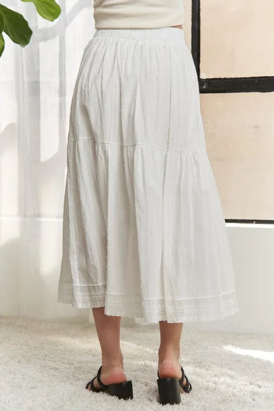 Jade Icarus ADORA elastic waistband tiered midi skirt in soft fabric, shown with a focus on the pleated, layered design.