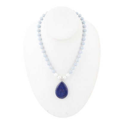 Denim blue angelite and lapis pendant silver necklace with intricate bead details, worn on a model&