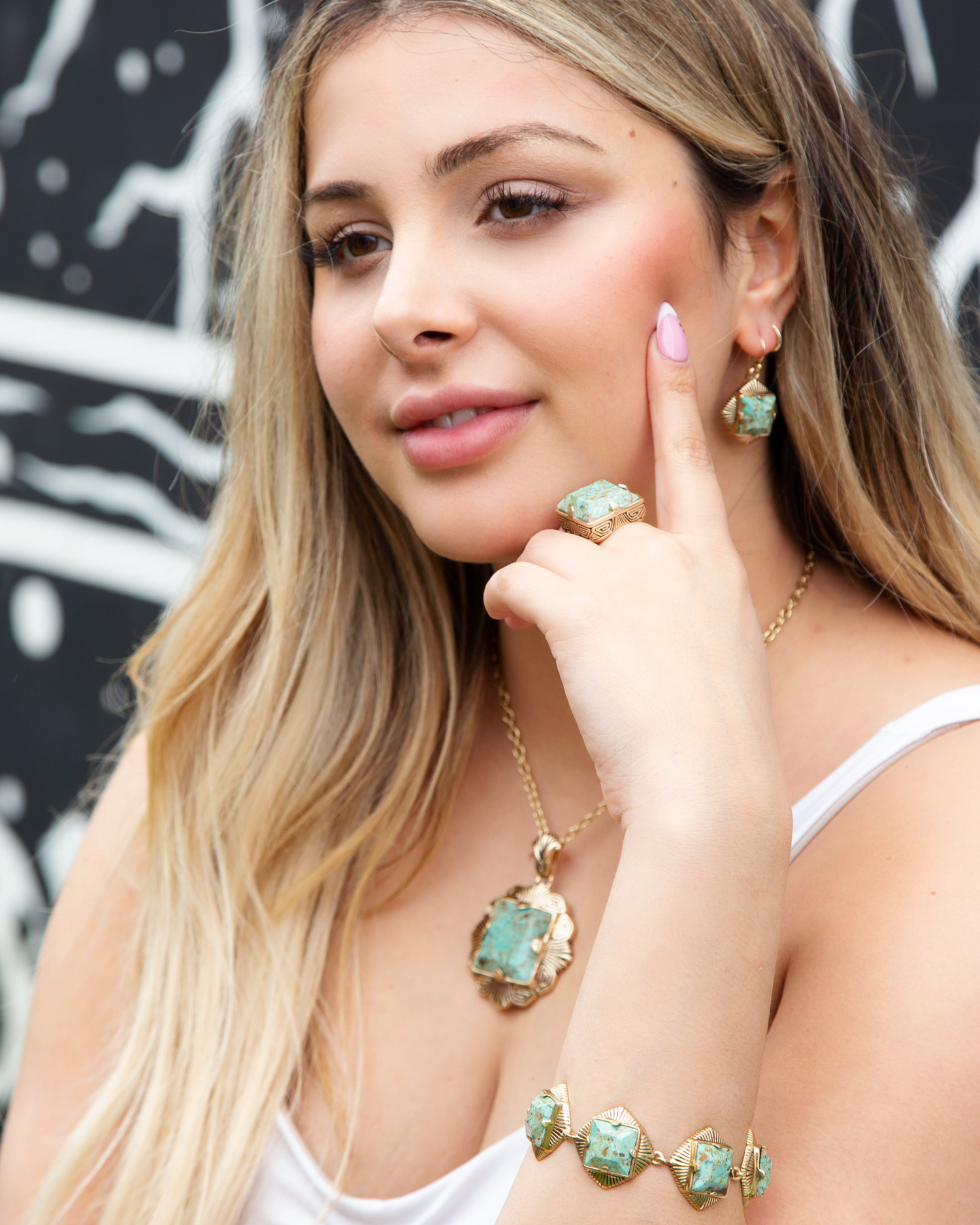 Blue turquoise and gold chunky earrings with bold jewelry design, featuring large circular turquoise stones and gold accents.