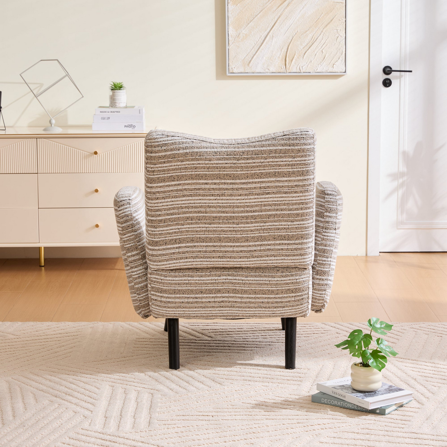 Modern armchair with sanded fabric, wooden legs, and a side storage pocket, featuring a sleek design by Start2Finish.