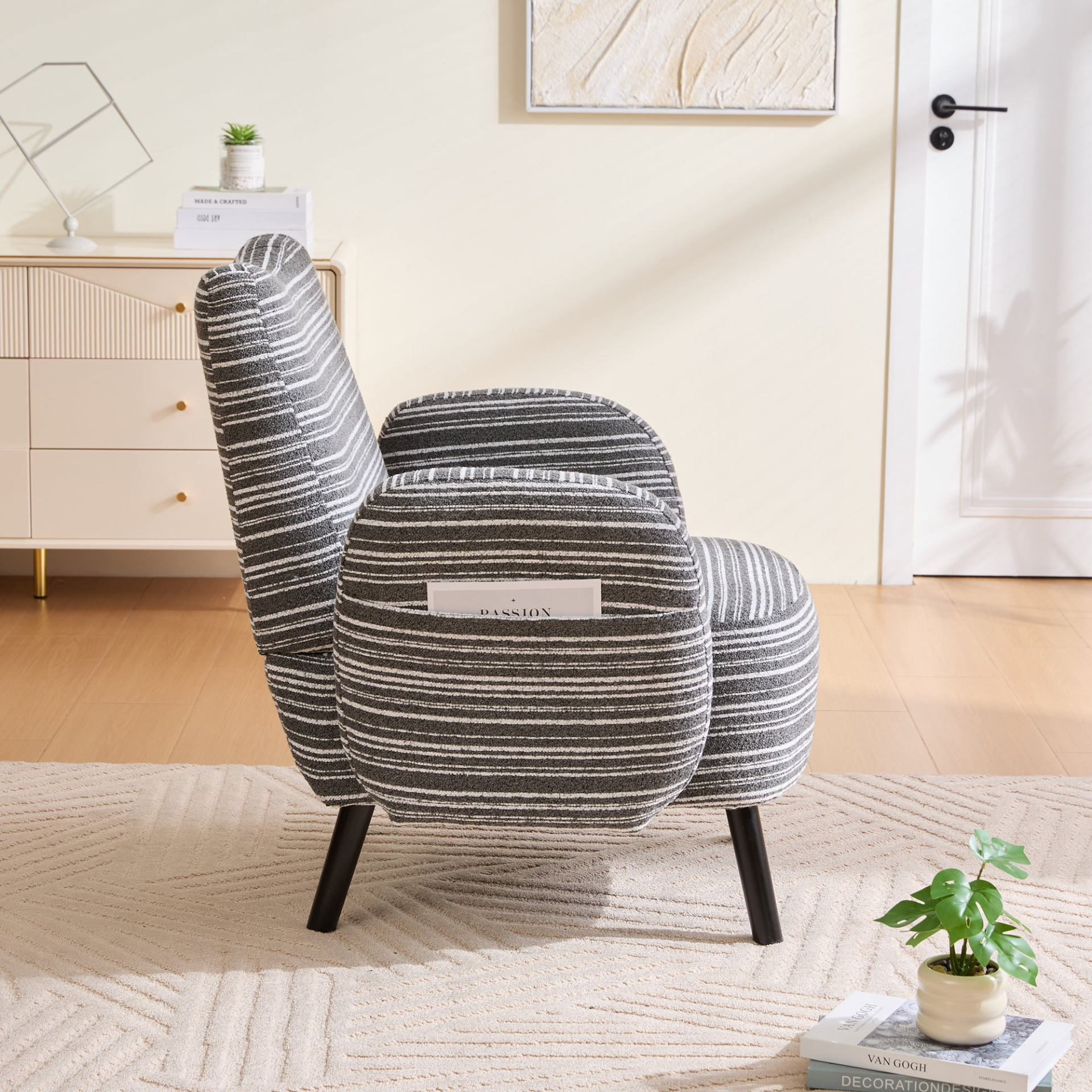 Modern armchair with sanded fabric, solid wood legs, and side storage pocket, showcasing a stylish and comfortable seating option.