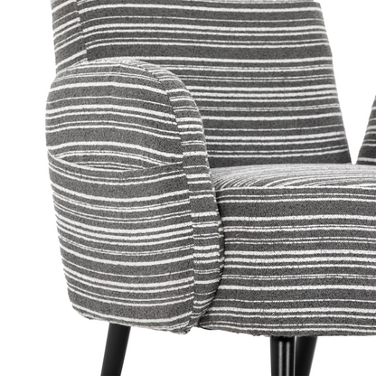 Modern armchair by Start2Finish with sanded fabric, side storage pocket, and solid wood legs in a stylish living room setting.