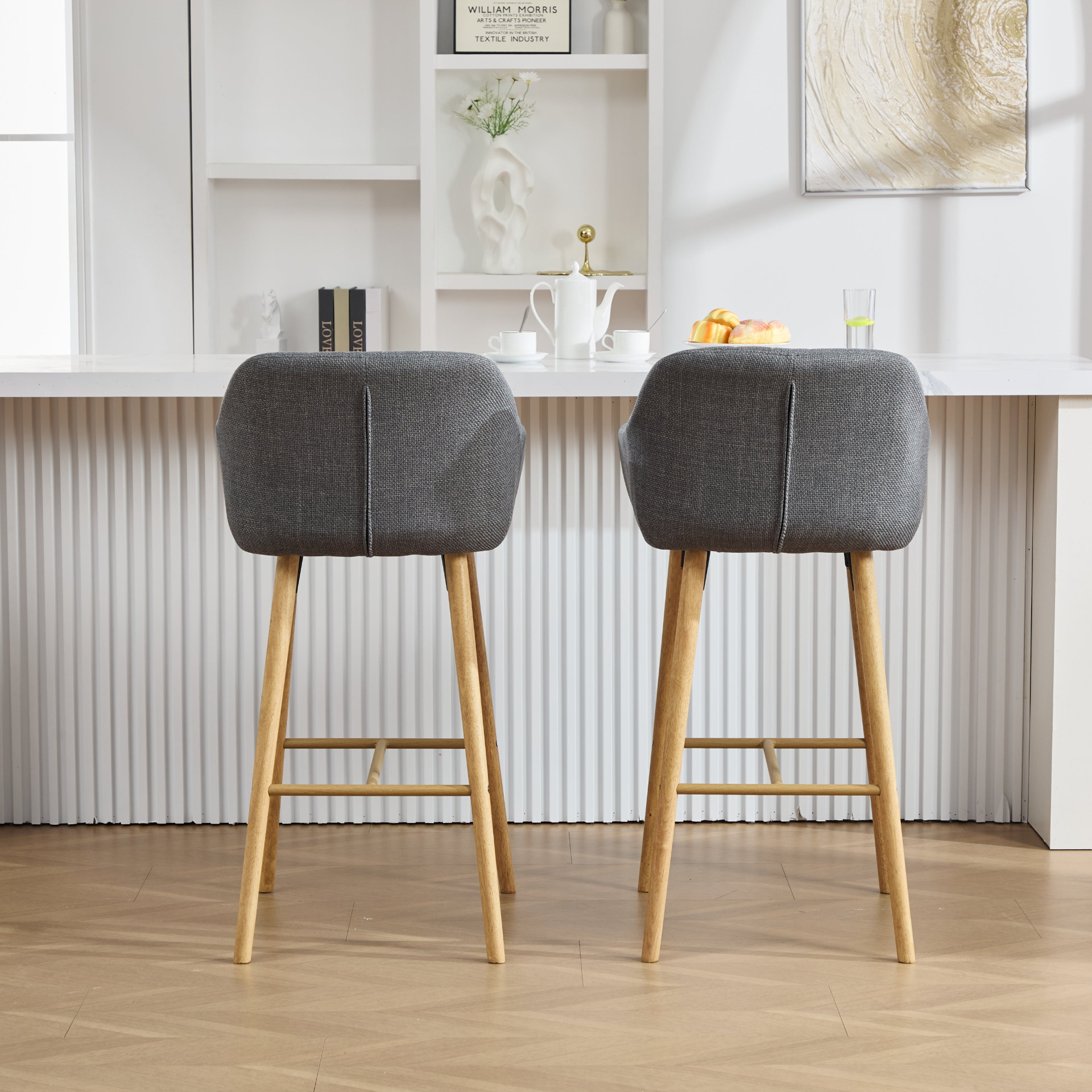 Modern linen upholstered bar stool with back, armrests, footrest, and solid wood legs from Start2Finish furniture.