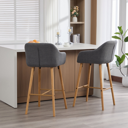 Modern linen upholstered bar stool with back, armrests, footrest, and solid wood legs, designed for stylish kitchen or bar area.
