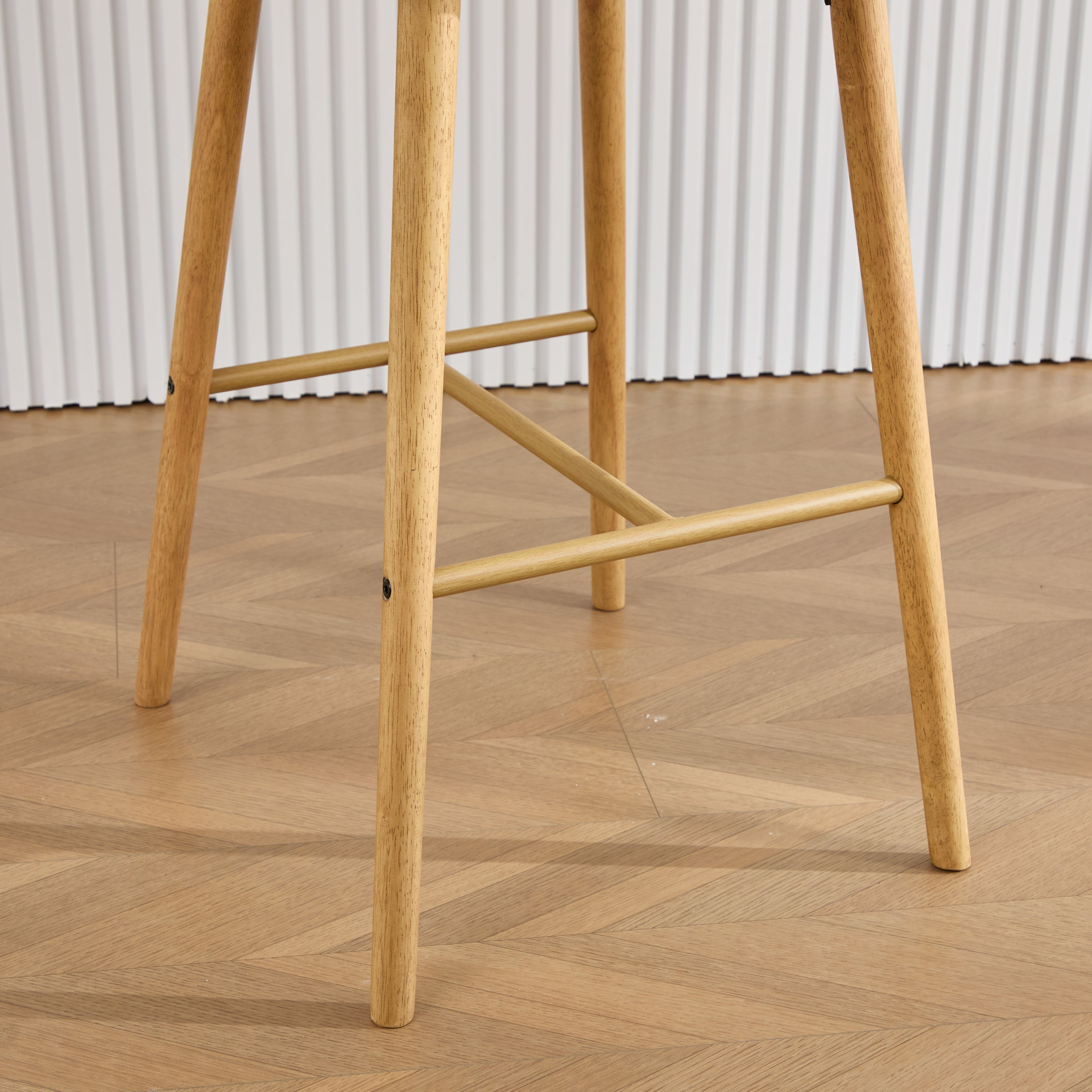 Modern linen upholstered bar stool with back, armrests, footrest, and solid wood legs, designed by Start2Finish.