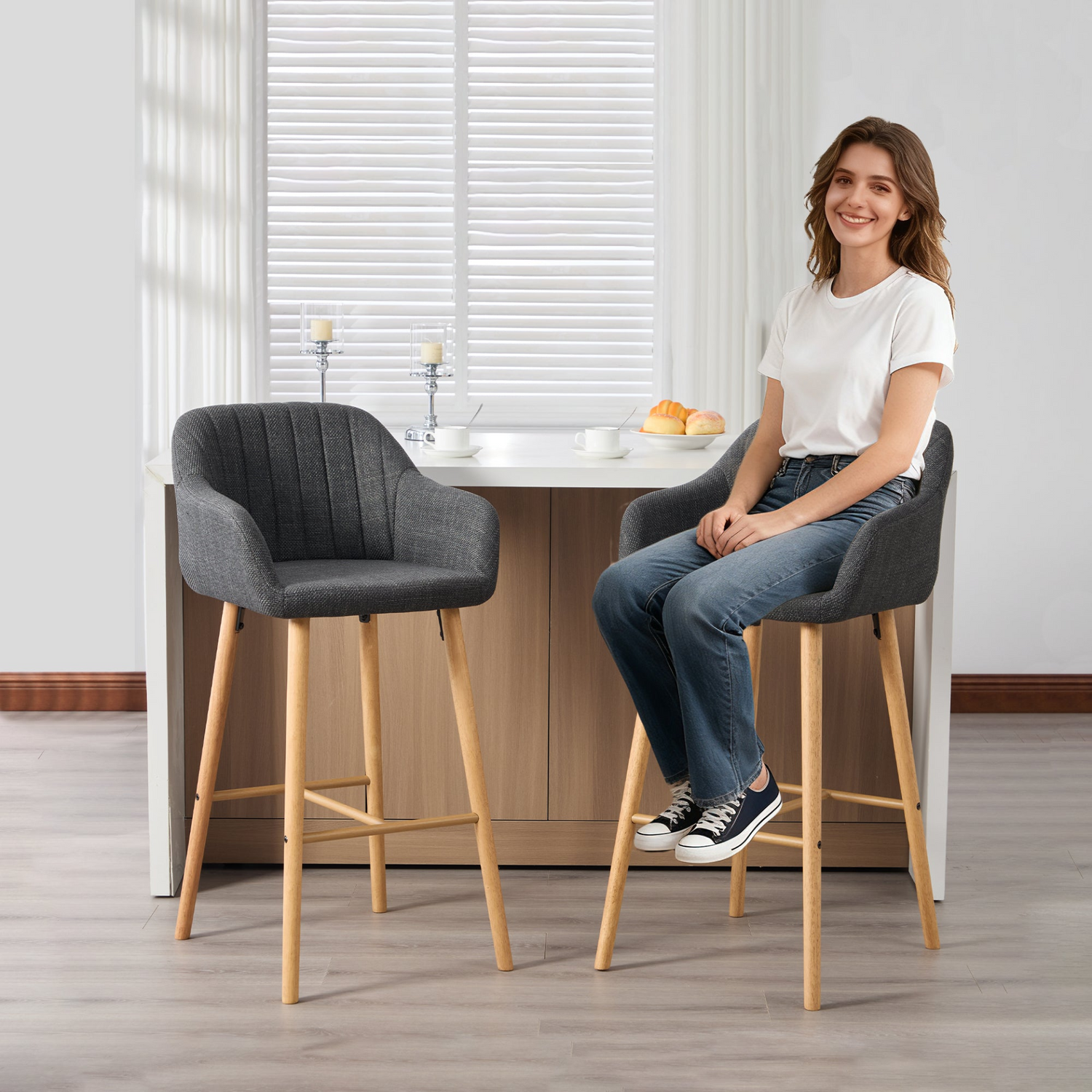 Modern linen upholstered bar stool with back, armrests, footrest, and solid wood legs from Start2Finish furniture.