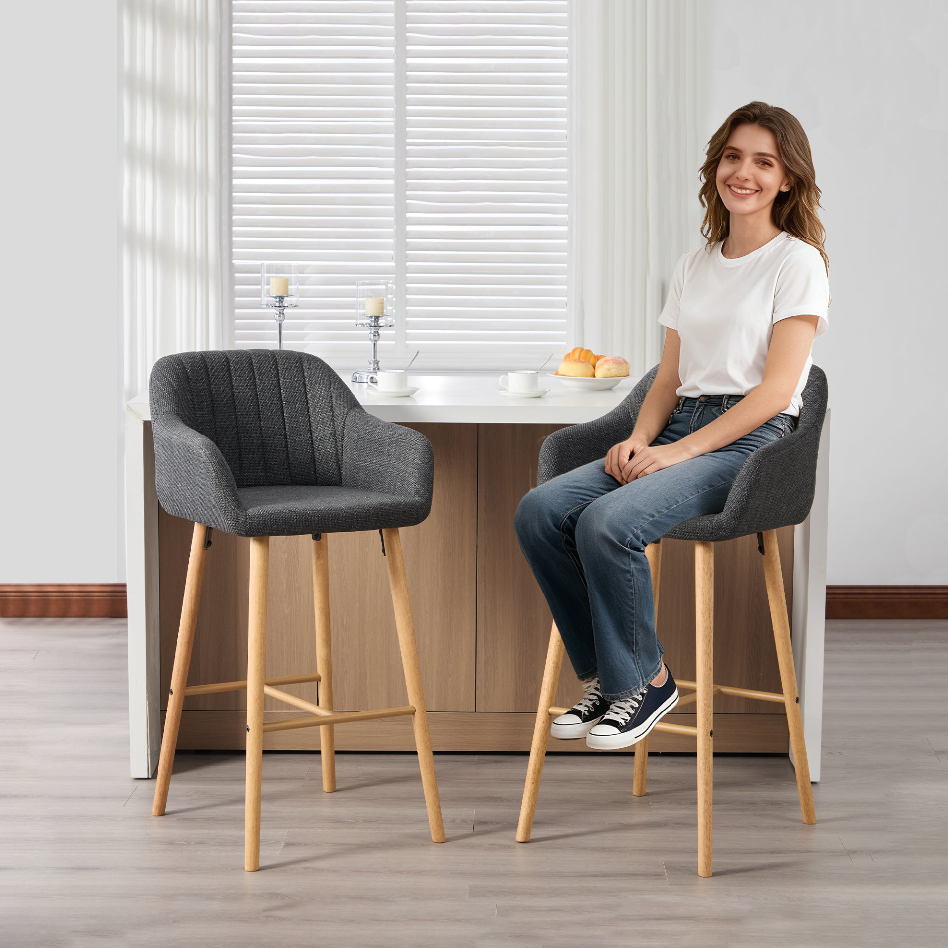 Modern linen upholstered bar stool with back, armrests, footrest, and solid wood legs from Start2Finish furniture.