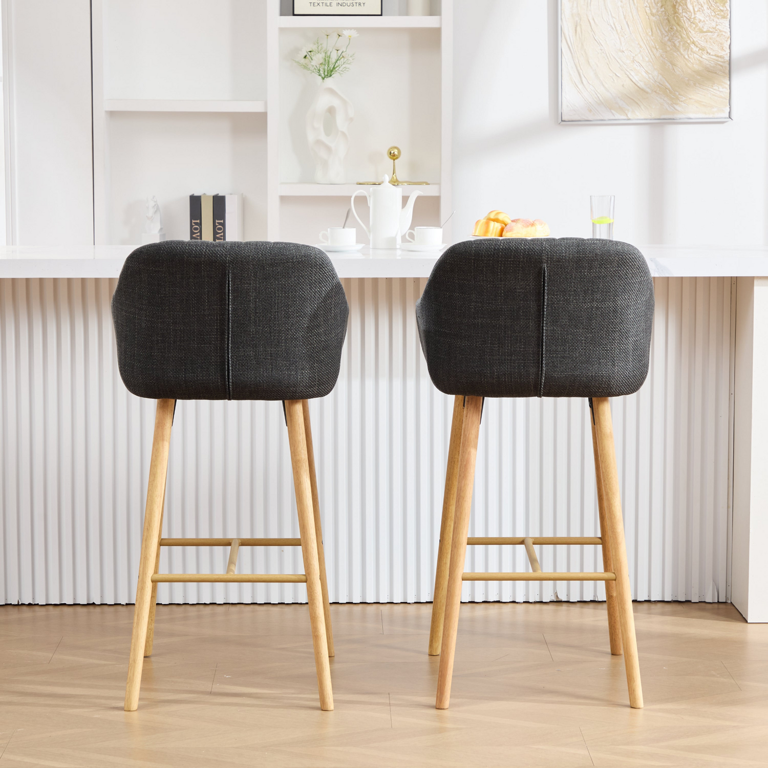 Modern linen upholstered bar stool with backrest, armrests, footrest, and solid wood legs from Start2Finish furniture.