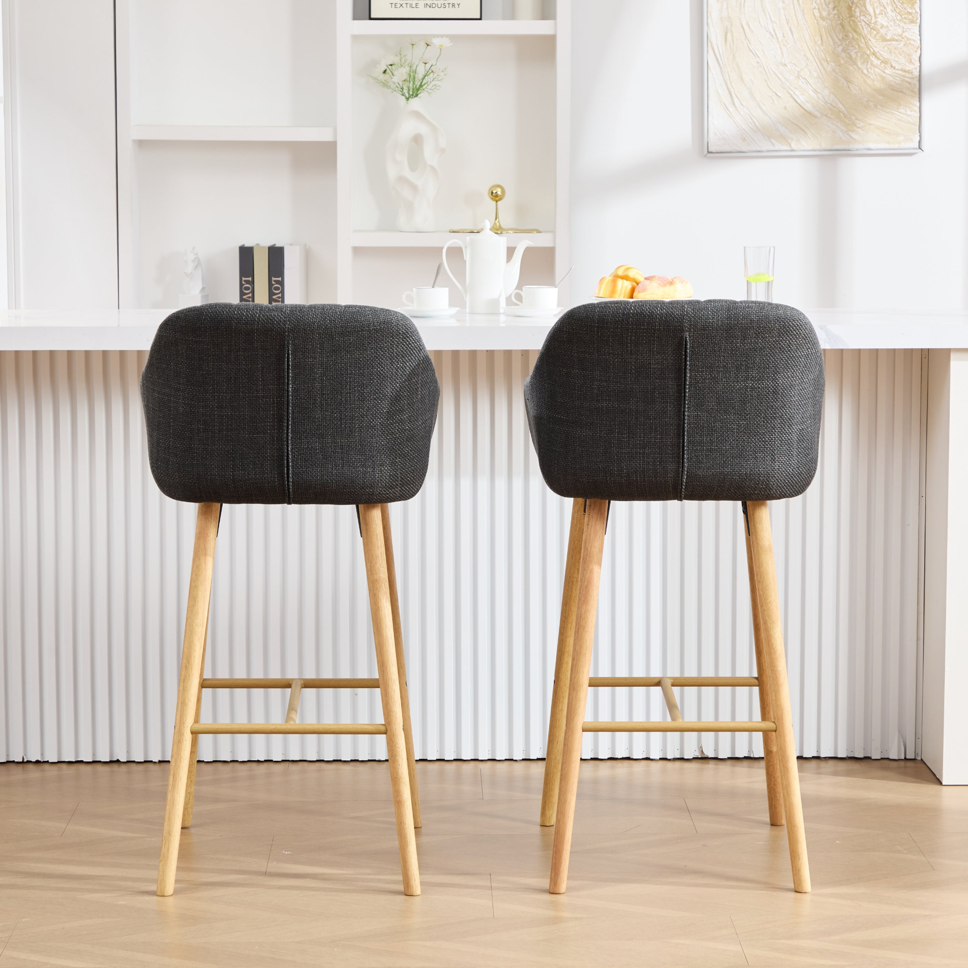 Modern linen upholstered bar stool with backrest, armrests, footrest, and solid wood legs from Start2Finish furniture.