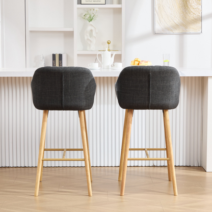 Modern linen upholstered bar stool with backrest, armrests, footrest, and solid wood legs from Start2Finish furniture.