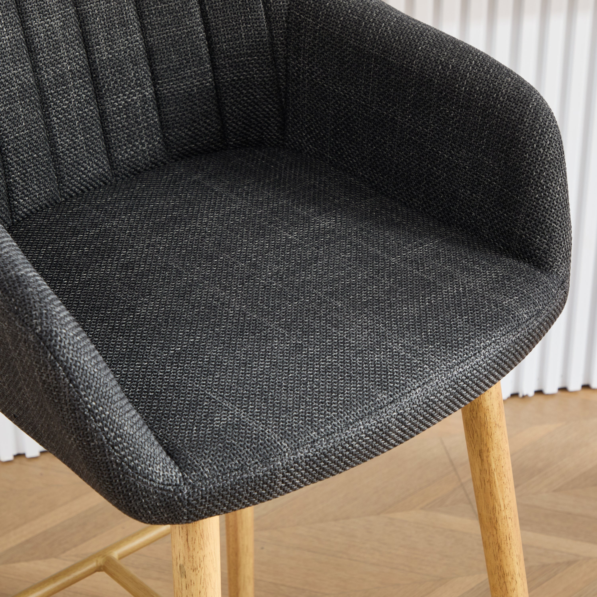 Modern linen upholstered bar stool with back, armrests, footrest, and solid wood legs from Start2Finish furniture.