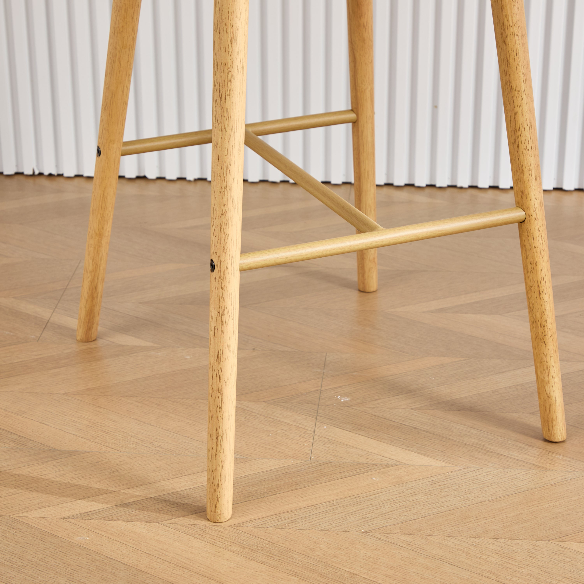 Modern linen upholstered bar stool with back, armrests, footrest, and solid wood legs, designed for stylish furniture decor.