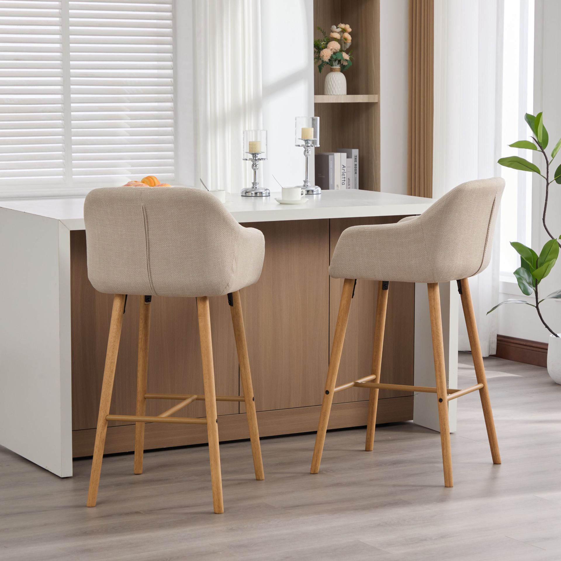 Modern linen upholstered bar stool with backrest, armrests, footrest, and solid wood legs from Start2Finish furniture.
