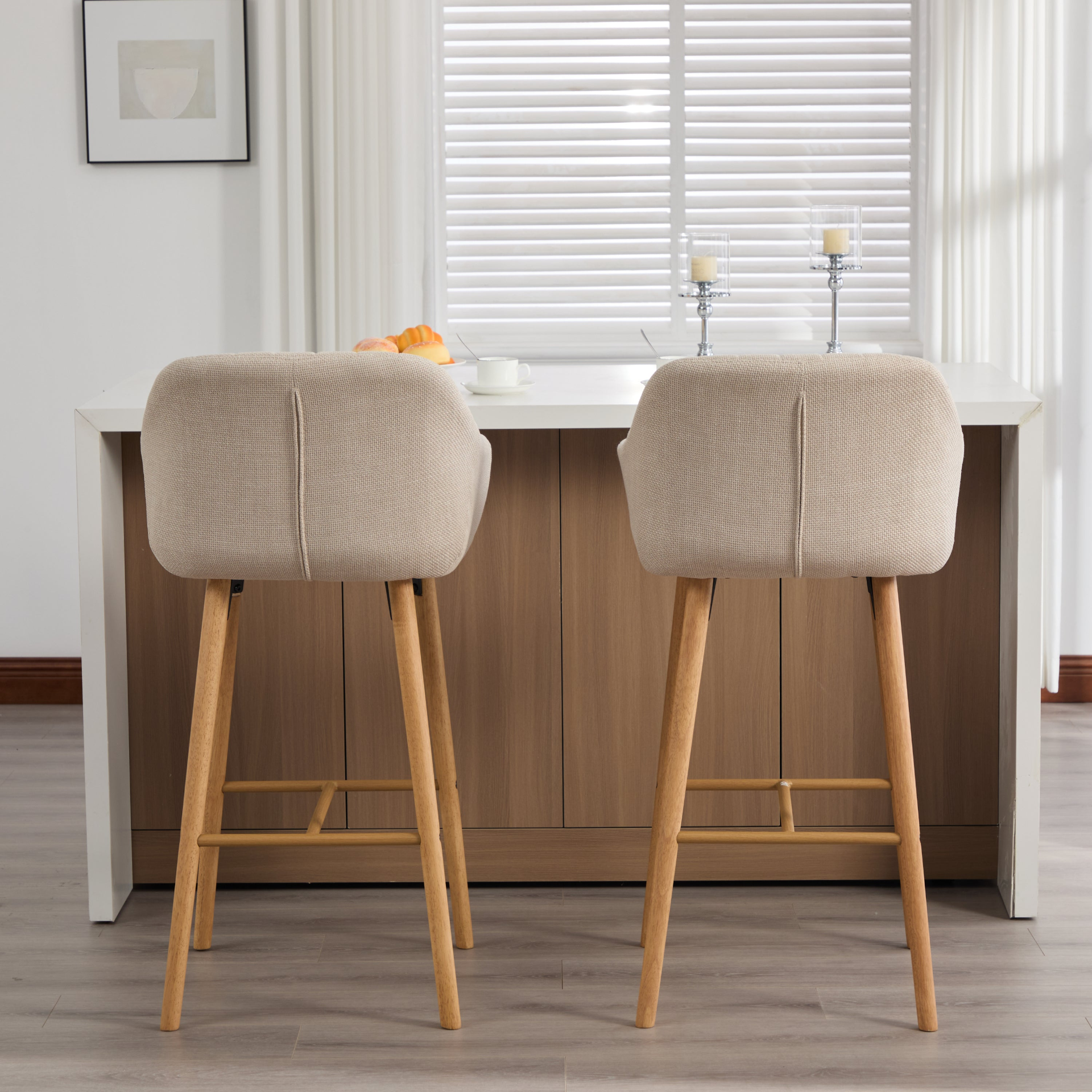Modern linen upholstered bar stool with back, armrests, footrest, and solid wood legs, featuring a stylish and comfortable design.