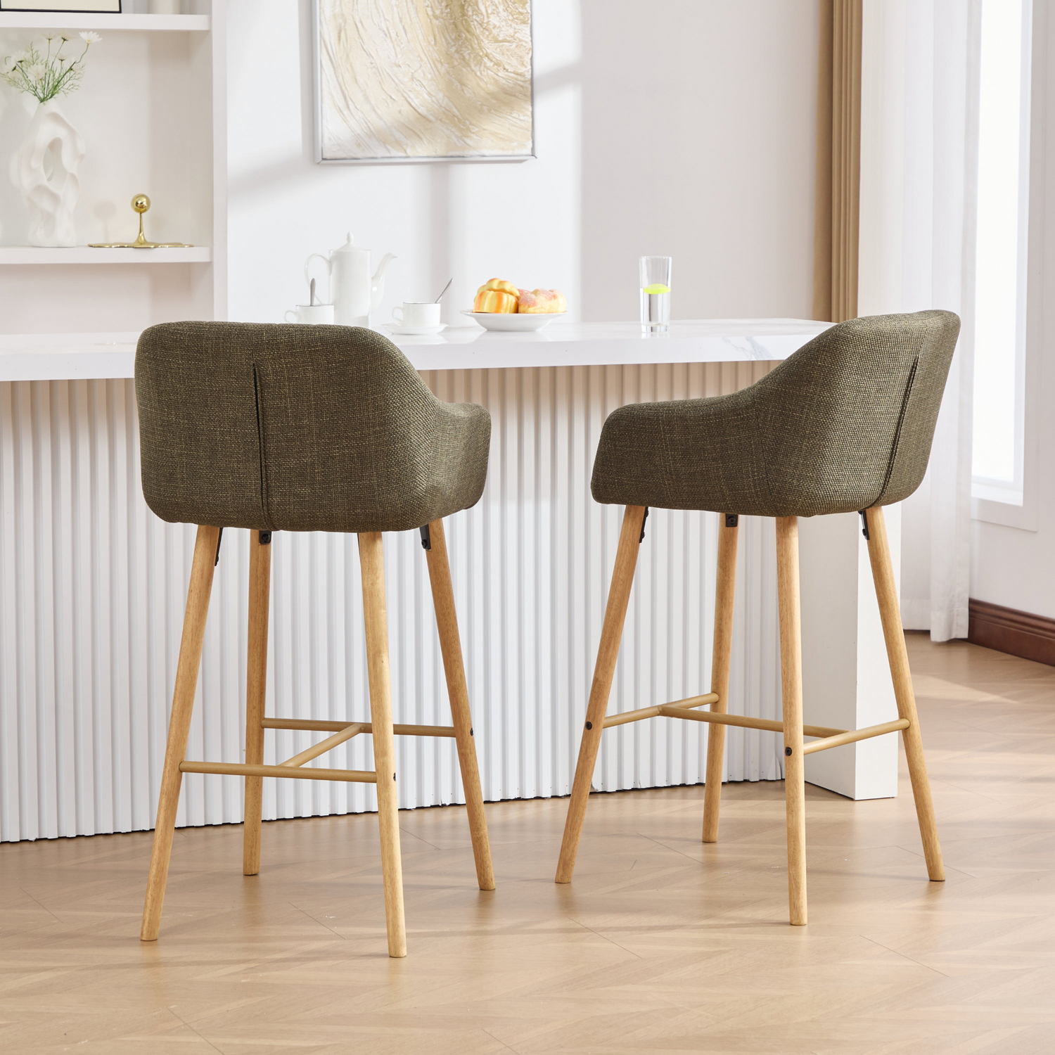 Modern linen upholstered bar stool with back, armrests, footrest, and solid wood legs, designed for stylish kitchen or bar seating.