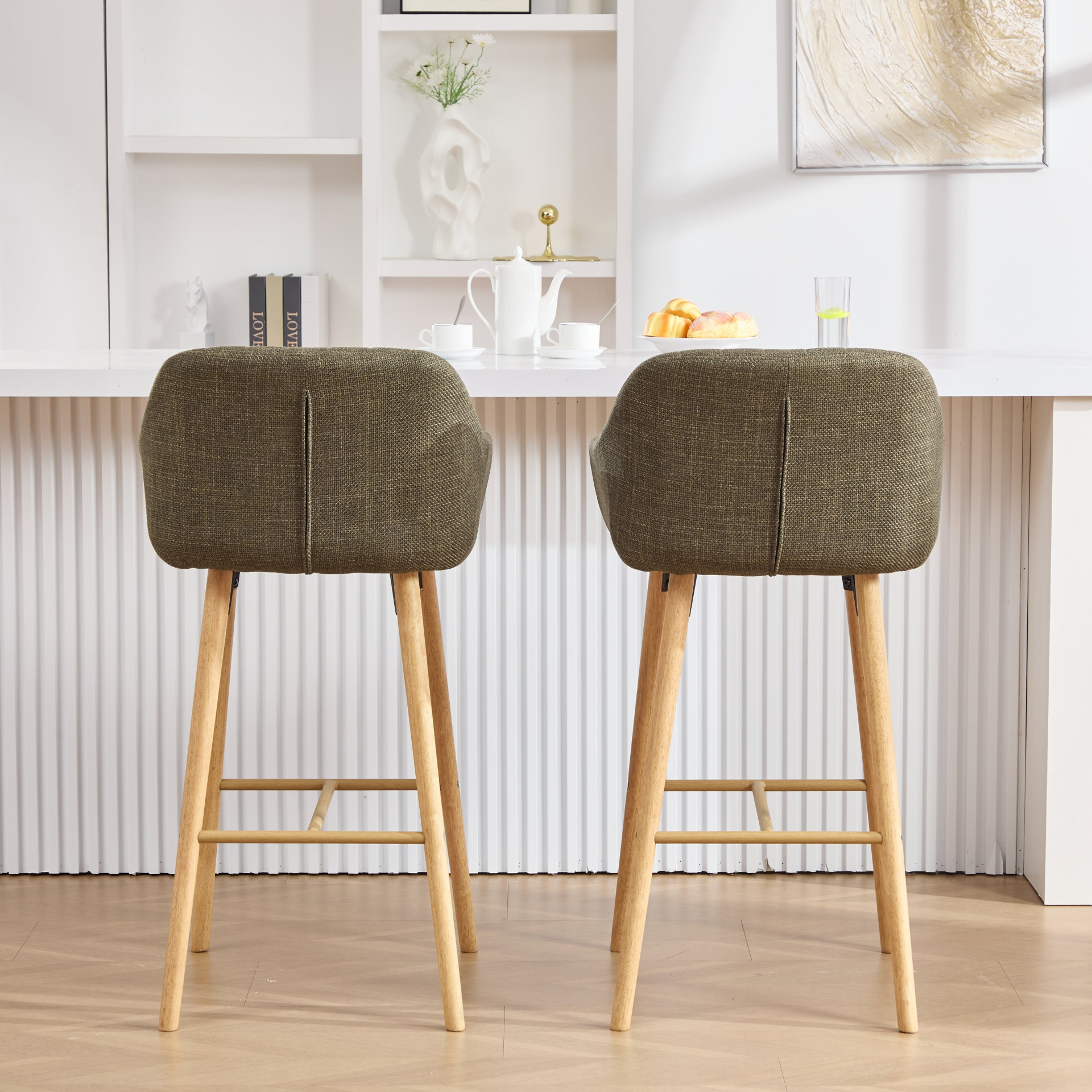 Modern linen upholstered bar stool with back, armrests, footrest, and solid wood legs from Start2Finish furniture.