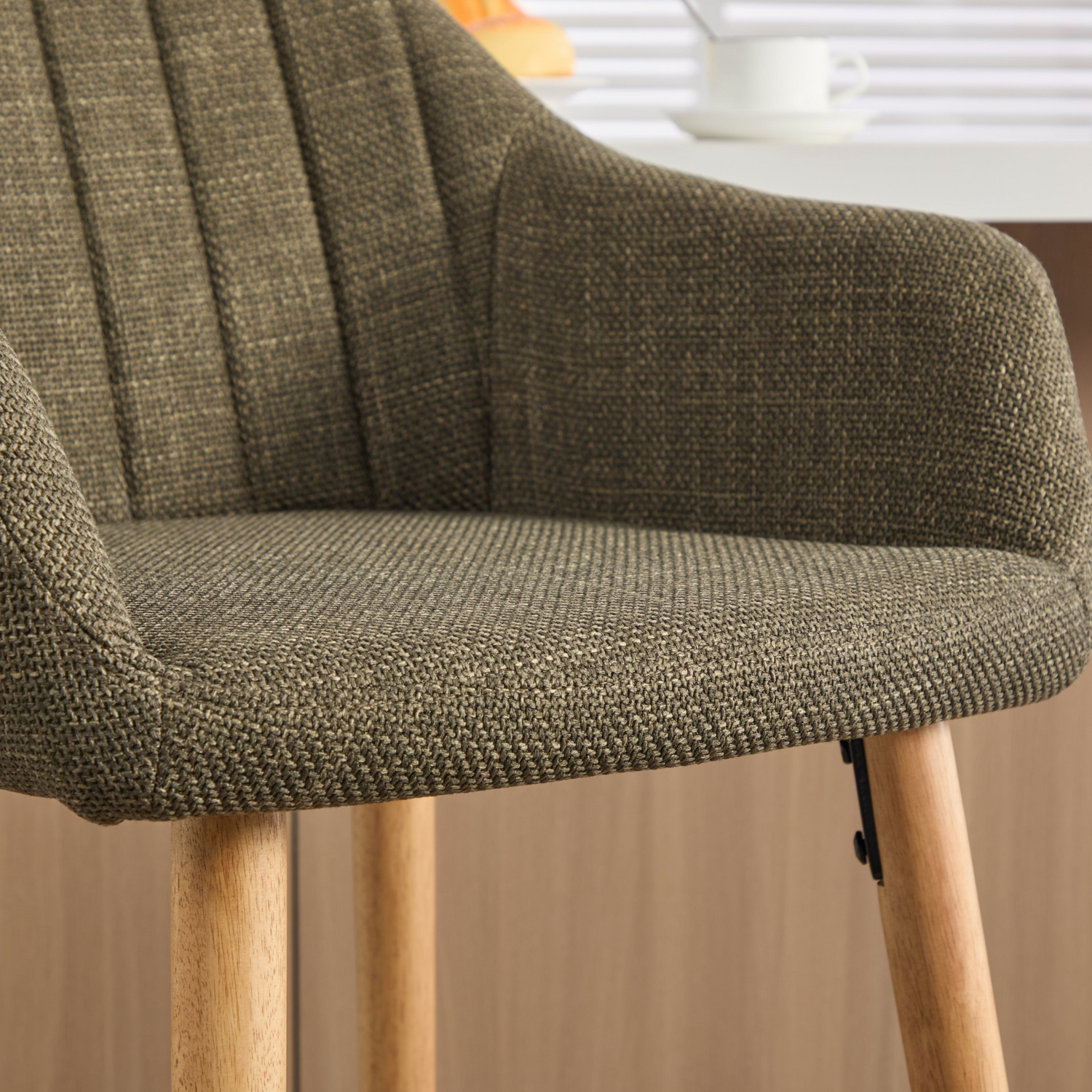 Modern linen upholstered bar stool with backrest, armrests, footrest, and solid wood legs from Start2Finish furniture.