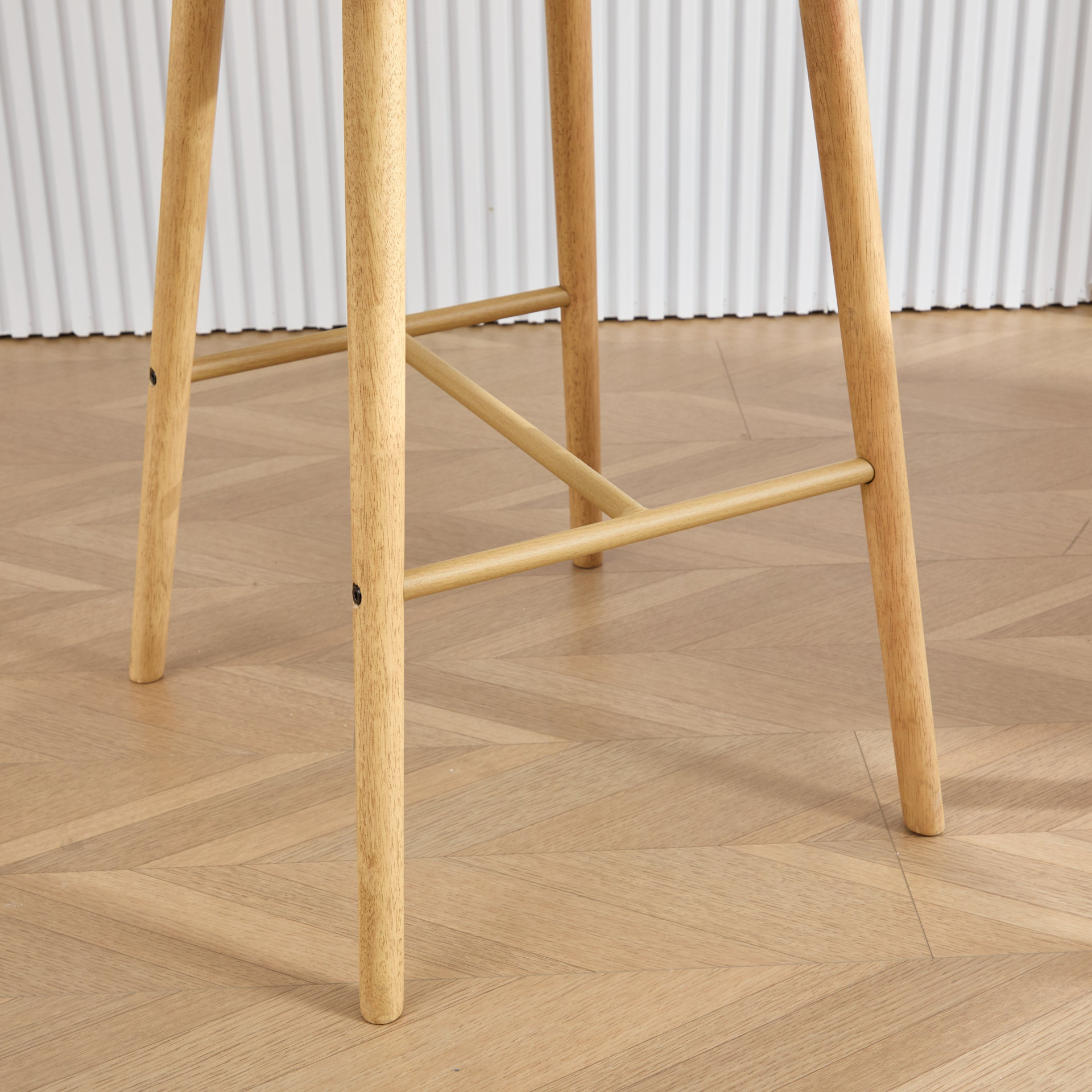 Modern linen upholstered bar stool with back, armrests, footrest, and solid wood legs from Start2Finish furniture.