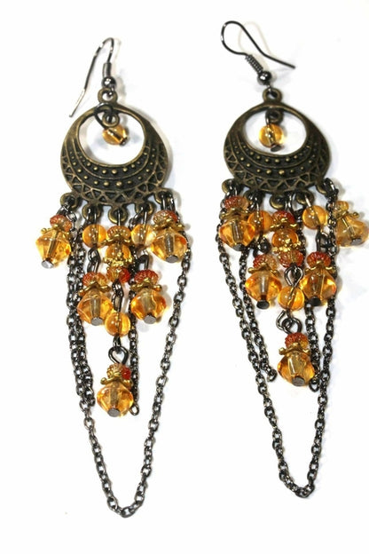 Silver Hestia gypsy style chandelier earrings with intricate silver detailing and dangling elements, hanging from pierced ears.