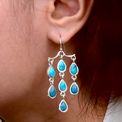 Sterling silver earrings featuring ombre blue turquoise and teal apatite gemstone drops, showcasing elegant jewelry design.