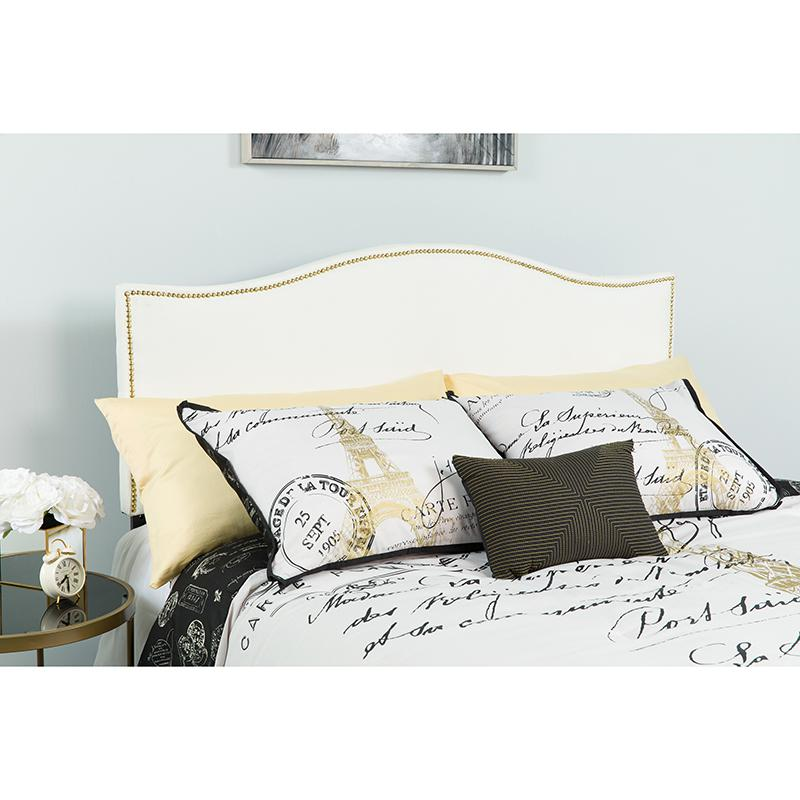 White fabric upholstered queen size headboard with accent nail trim, showcasing a stylish and padded furniture piece.
