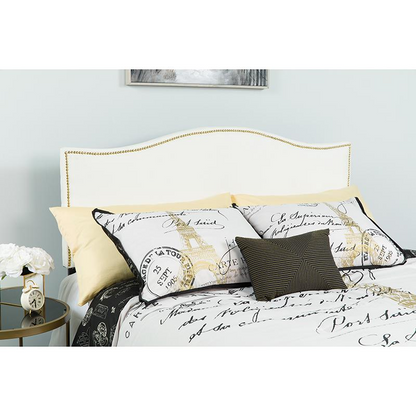 White fabric upholstered queen size headboard with accent nail trim, showcasing a stylish and padded furniture piece.