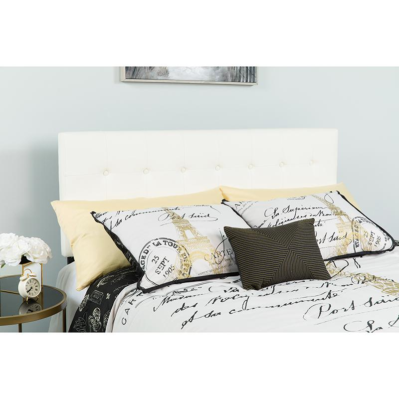 Tufted upholstered full-size headboard in white vinyl with button-tufted design, displayed in a bedroom setting.