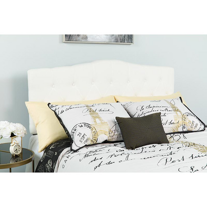 White tufted upholstered full-size headboard in fabric, featuring a padded, elegant design for bedroom furniture.