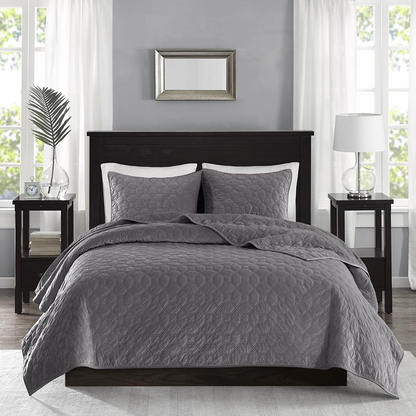 Start2Finish Harper 3-piece grey velvet quilt set with matching pillow shams on a bed, showcasing luxurious bedding.