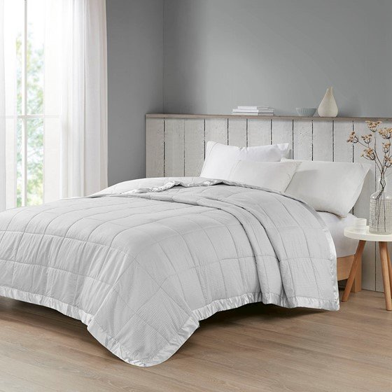 Oversized down alternative bedding blanket with satin trim by Start2Finish, shown in a cozy, plush fabric with elegant satin edging.