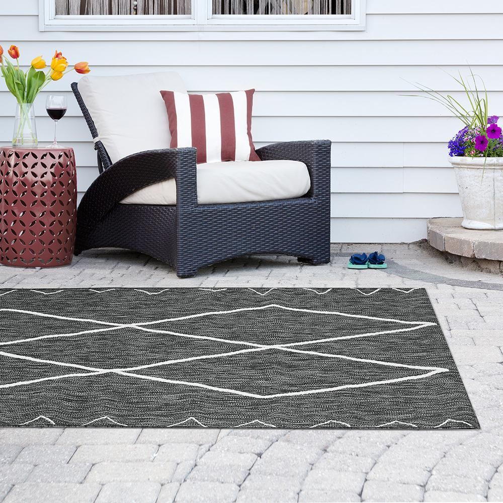 Start2Finish Moroccan indoor/outdoor rug with intricate geometric patterns in vibrant colors on a textured fabric surface.