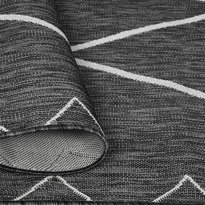 Moroccan indoor/outdoor rug by Start2Finish featuring intricate geometric patterns in vibrant colors on a textured surface.