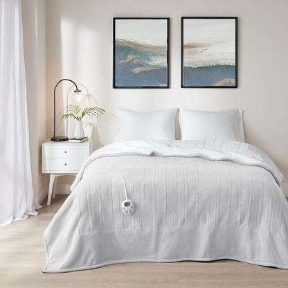 Start2Finish heated blanket in cozy bedding, showing soft fabric and control cord for adjustable warmth.