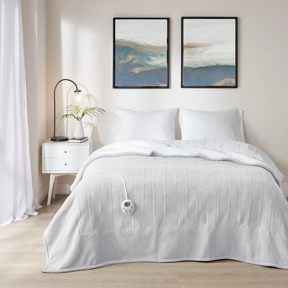 Start2Finish heated blanket with plush fabric and adjustable temperature settings, shown spread out on a bed.