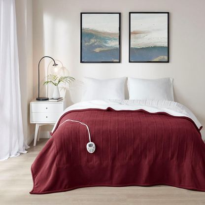 Start2Finish heated blanket draped over a cozy bed, showcasing its plush fabric and electric heating elements for warmth and comfort.