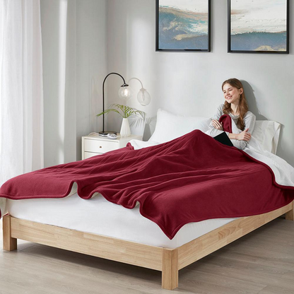 Start2Finish heated blanket spread out on a bed, showcasing its soft fabric and cozy design for warmth and comfort.