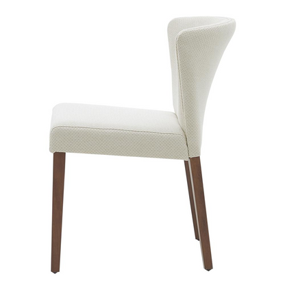 Set of two Start2Finish Albie fabric dining side chairs with cushioned seats and wooden legs, shown in a modern dining room setting.
