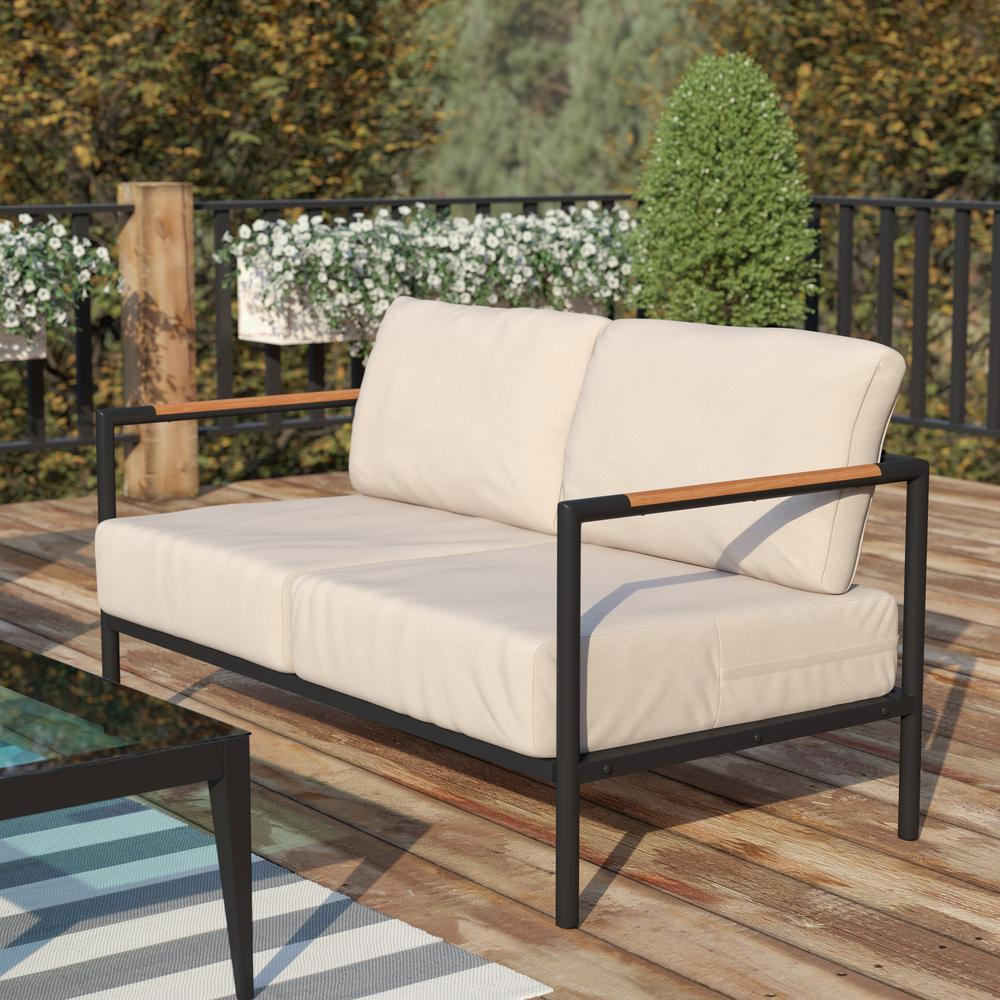 Black patio loveseat with beige cushions and teak accent arms, outdoor furniture by Start2Finish.