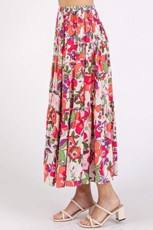 Pink flower print elastic waist tiered skirt by Mittoshop, styled with a floral pattern and flowy fabric.